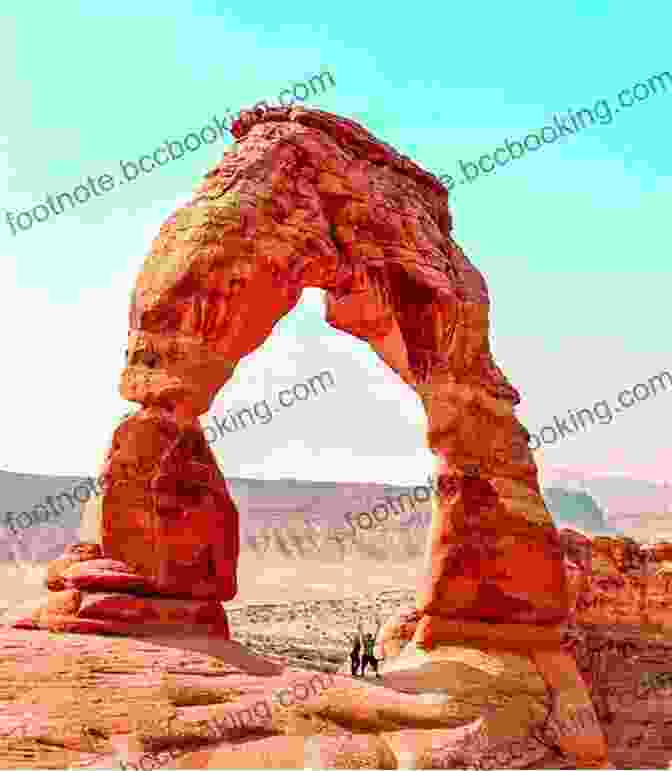 A Close Up Of Delicate Arch In Arches National Park, With A Hiker Standing Beneath It Fodor S Utah: With Zion Bryce Canyon Arches Capitol Reef And Canyonlands National Parks (Full Color Travel Guide)